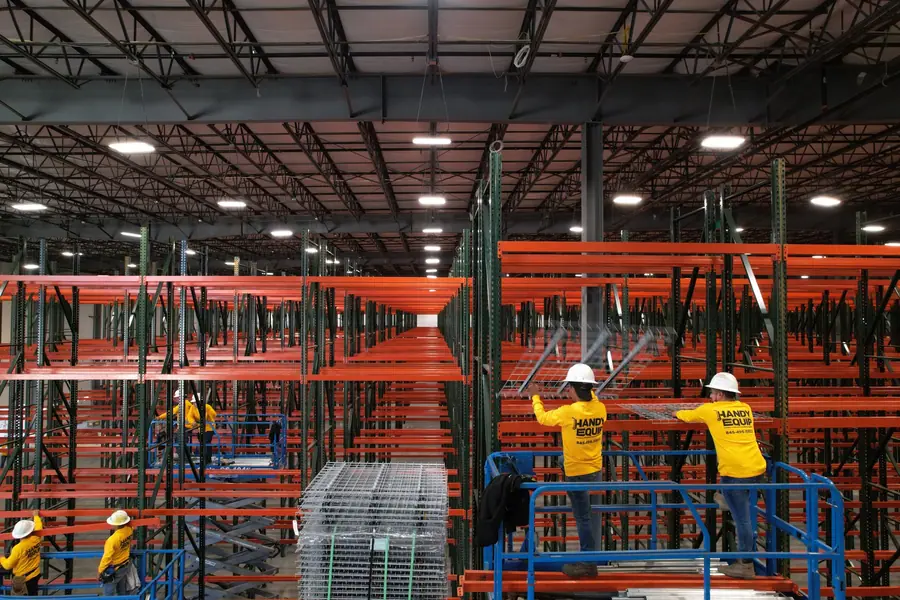 Crew installing wire mesh decking on beams