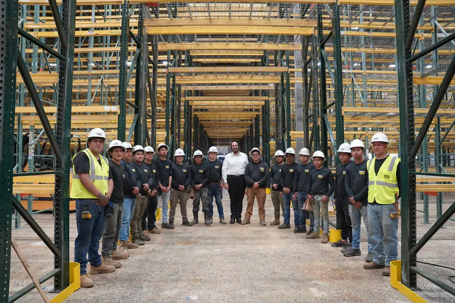 Crew in warehouse racking aisle