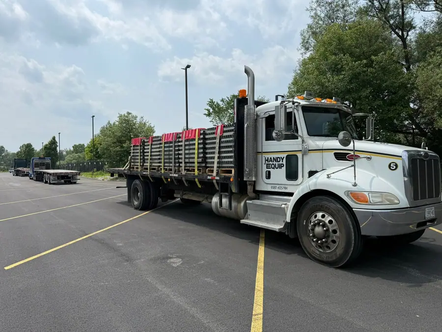Flatbed loaded with racking front three-quarter