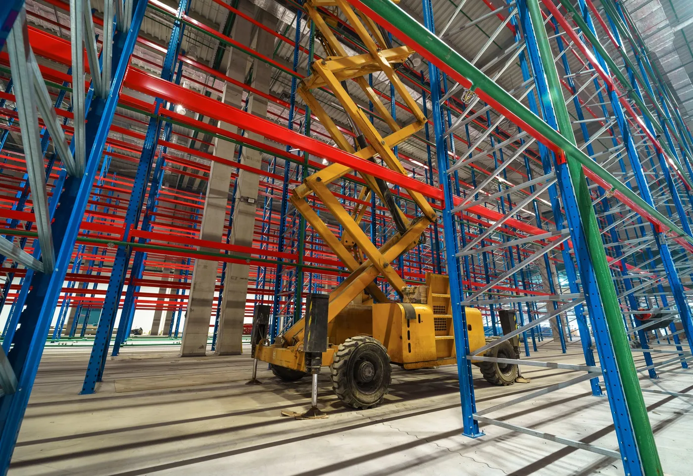 Pallet racking going up with a scissor lift