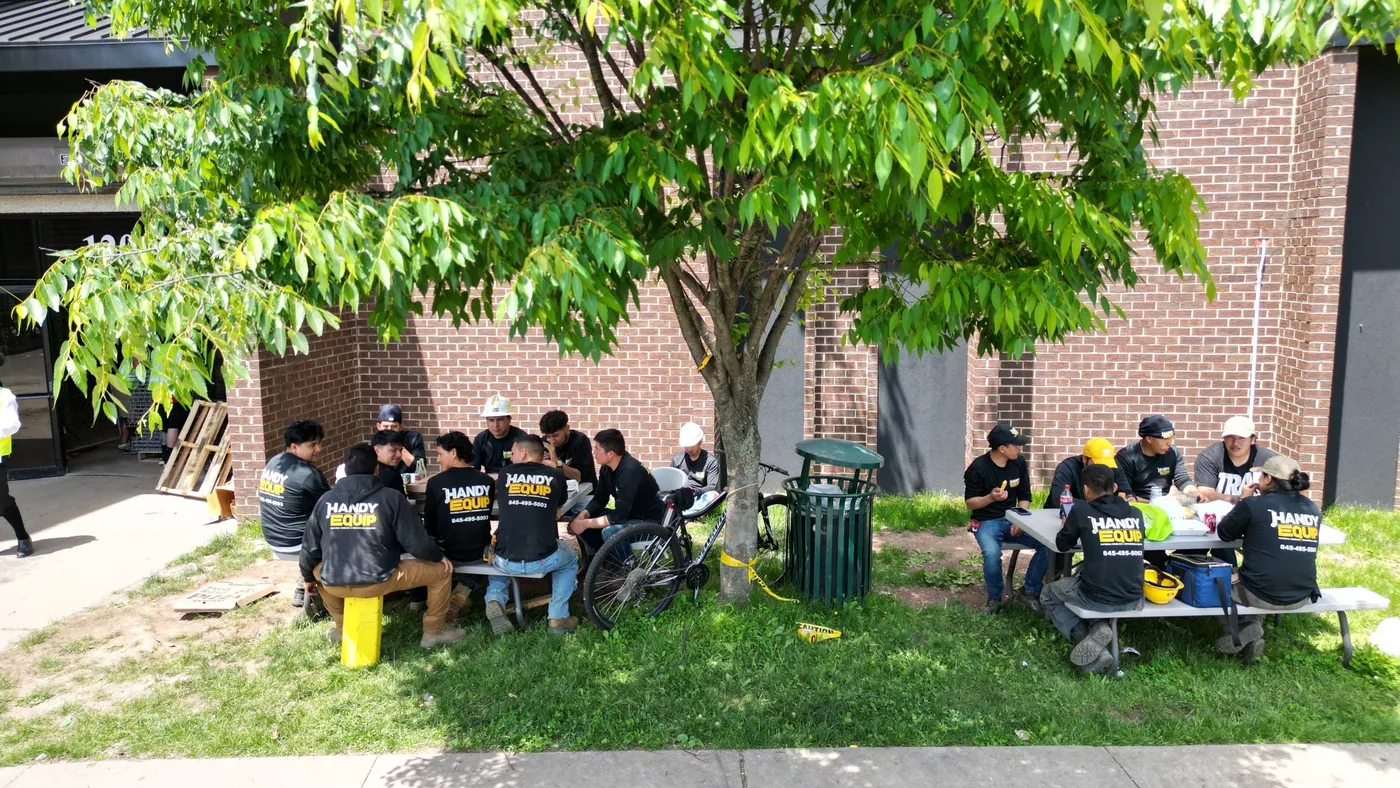The Handy Equip crew eating lunch together outside a job.